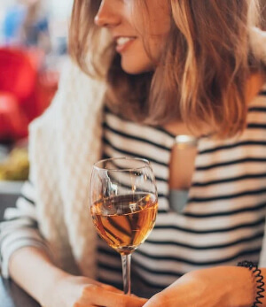 A woman drinking wine in East Hampton